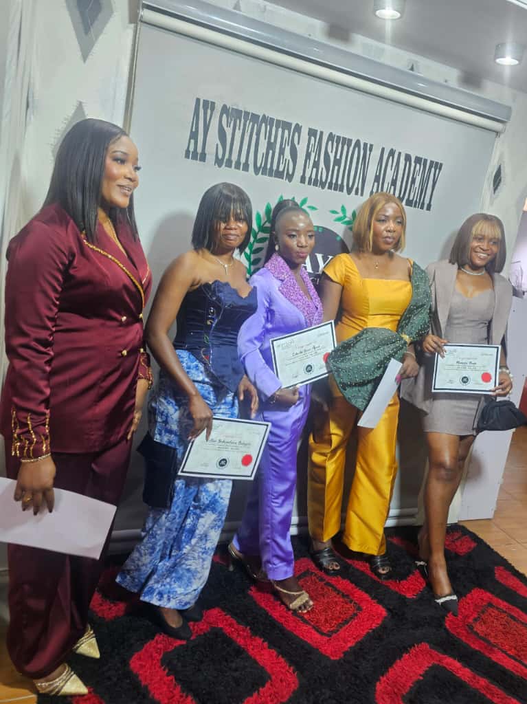 Five women holding their graduation certificates